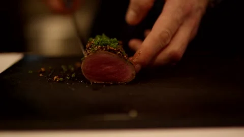 Seared Meat Fillet with Herb Crust on Dark Board, Restaurant Kitchen, Close Up Stock Footage 341345387