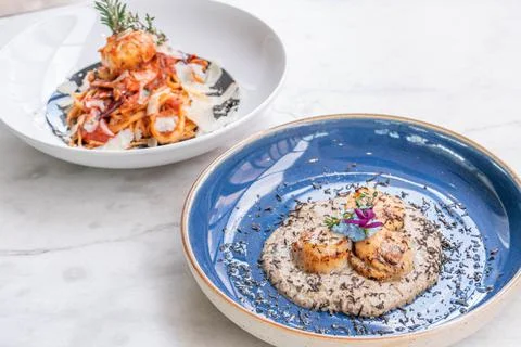 Seared scallop appetizer in dish Stock Photos