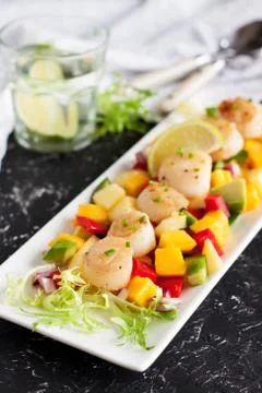 Seared scallops with mango and pineapple salsa Stock Photos