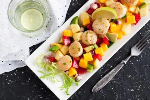 Seared scallops with mango and pineapple salsa Stock Photos