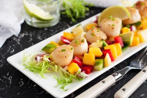 Seared scallops with mango and pineapple salsa Stock Photos