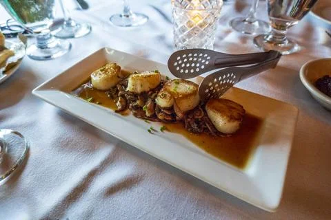 Seared scallops served on a rectangular plate. Stock Photos