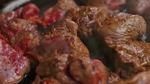 Searing Beef Chunks in a Pan, Close Up Panorama Stock Footage 314377239