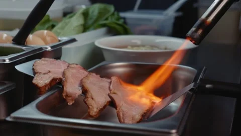 Searing Beef Slices with a Gas Torch, Slow Motion Video stock 340194201
