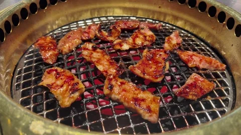 Searing Meat Over Charcoal Flames at Japanese Barbecue Stock Footage 329290874