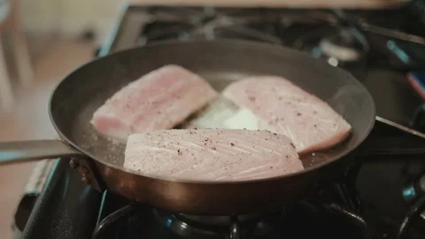 Searing raw fish in skillet Stock Footage 295001437