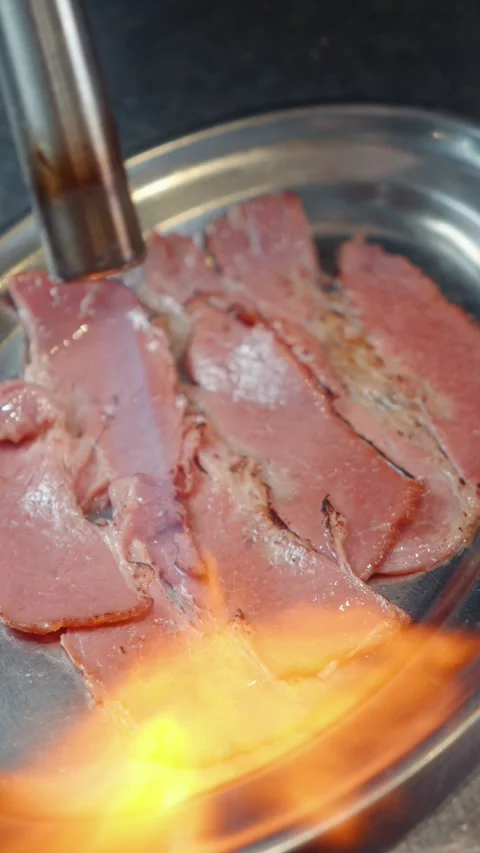 Searing Thin Slices of Meat with Culinary Blowtorch Stock Footage 341404334