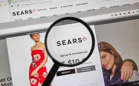 Sears Canada web page under magnifying glass. Stock Photos