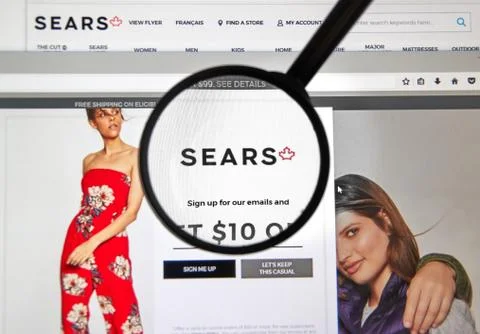 Sears Canada web page under magnifying glass. Stock Photos