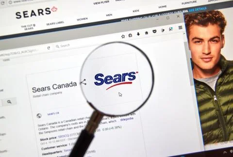 Sears Canada web page under magnifying glass. Stock Photos