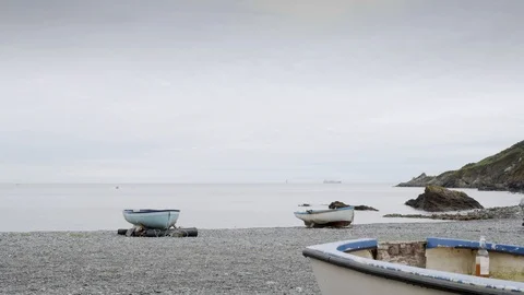 Seascape backdrop with rowing boat in the foreground stock footage Video stock 116709387