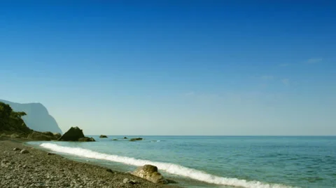 Seascape: beach, waves, rocks and mountain Stock-Footage 47614005