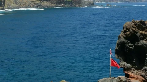 Seascape with broken red flag moved by the wind. Stock Footage 71791173