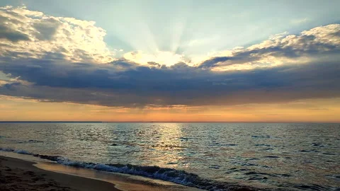 Seascape Dark rainy clouds blue sky over sea Sunbeams behind clouds Stock Footage 323127723