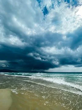 Seascape with a dramatic scene, heavy clouds over the sea with waves. Sun Stock Photos
