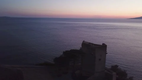 Seascape, dusk time with an ancient tower in foreground Stock Footage 105239356