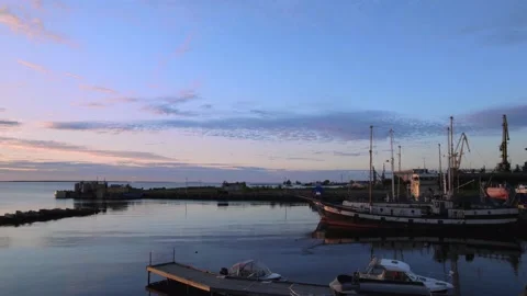 Seascape flight view with barges during sunrise. Blue lake and colorful sky with Stock Footage 159081916