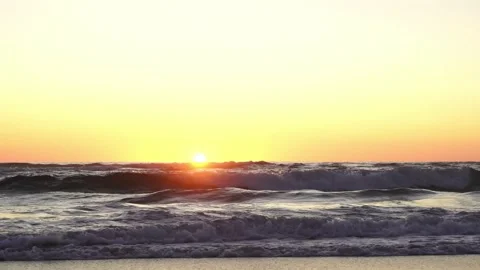 Seascape with horizon at sunset, rolling waves and yellow sky, Paris in France Stock Footage 145679333