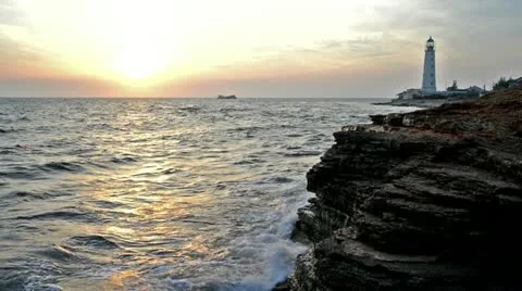 Seascape with lighthouse at sunset 스톡 동영상 12290643