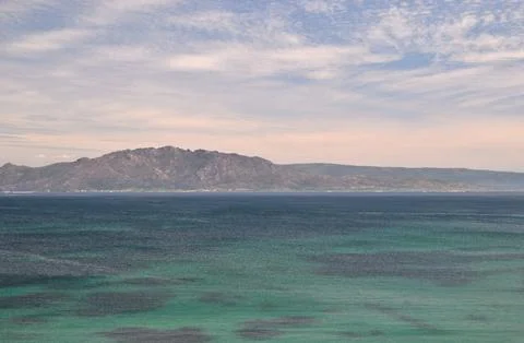 Seascape with mountain in the background Stock Photos