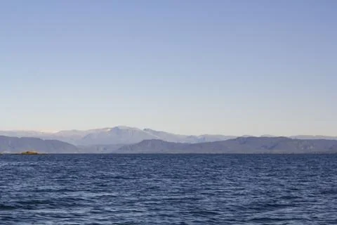 Seascape with mountains on the background Stock Photos