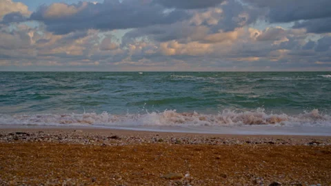Seascape of Rolling Waves and Cloudy Sunrise on Sandy Beach Stock Footage 318324467