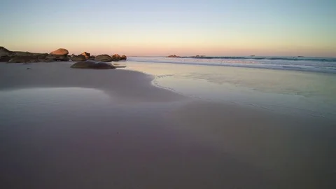 Seascape scenery on a sandy beach in the evening - golden hour - boulders… Stock Footage 78016356