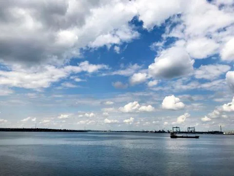 Seascape with a ship and clouds. Stock Photos
