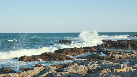 Seascape. A slow motion huge waves break about the rocky beach Stock Footage 94449222