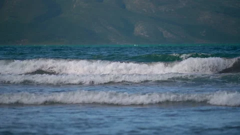 Seascape with sparkling waves lapping on the beach and rolling in tubes. Video stock 157489135