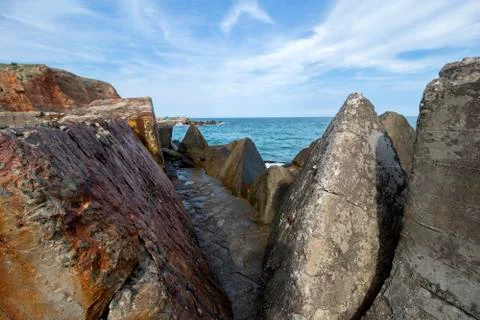 Seascape. A stone path between huge concrete blocks. Stock Photos
