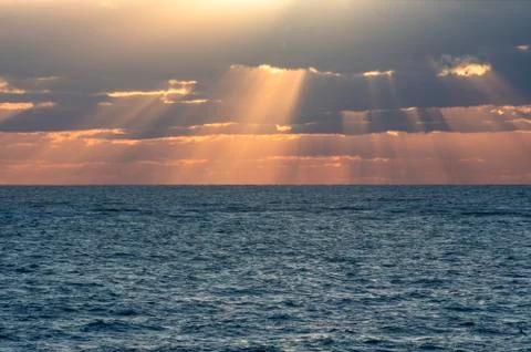 Seascape. The sun's rays break through the clouds Stock Photos