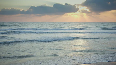 A seascape at sunset. Rays of the sun break through the clouds Stock Footage 304967472
