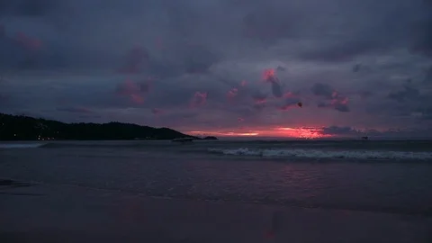 Seascape at sunset reflected on wet beach sand with incoming waves. motor boats Video stock 90801187