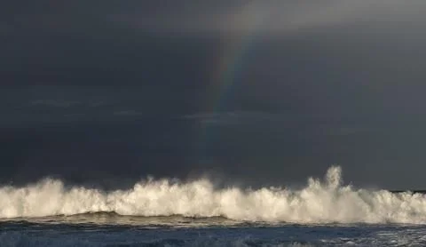 Seascape. Thunderclouds and rainbow over the ocean. Stock Photos