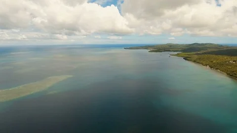 Seascape with tropical island, beach, rocks and waves. Siargao, Philippines. Stock Footage