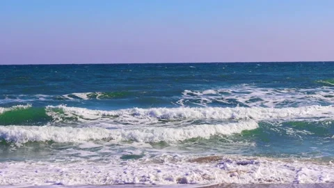 Seascape, waves roll on the shore, sunny day, cloudless sky Stock Footage 233029651