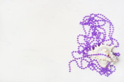 Seashell and lilac beads abstract Christmas decoration on white. Stock Photos