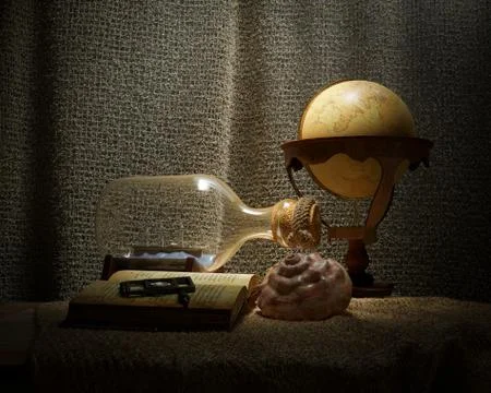 Seashell in interior scene with globe and ship in the bottle concept photo Stock Photos