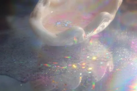 Seashell in sequins and water Stock Photos