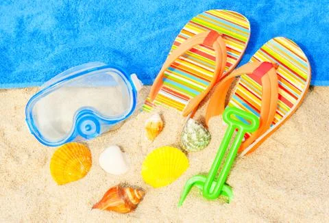 Seashells and diving mask on the beach Stock Photos