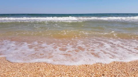 Seashells on sand beach with sea waves, close up Stock Footage 91934018