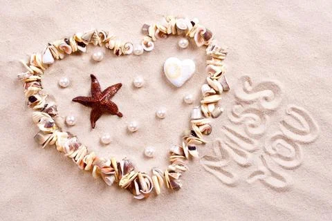 Seashells in sand seashells in sand in the form of heart with text Copyrig... Stock Photos