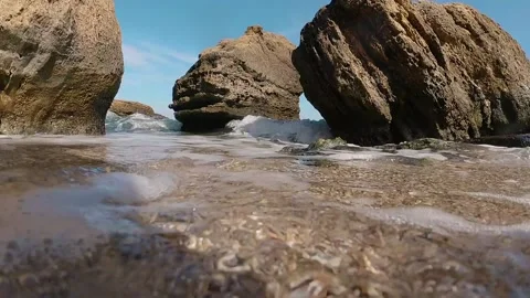 Seashore, close-up tide waves against the background of the horizon and stones Stock Footage 141572419
