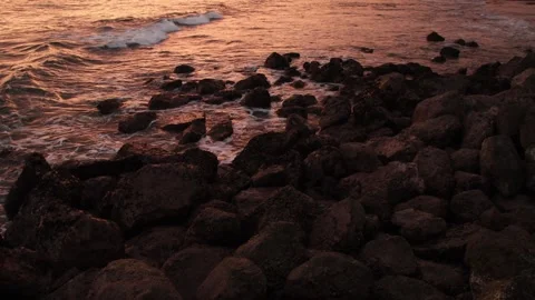 Seashore landscape at sunset with smooth waves and rock formations illumina.. Stock Footage 326374589