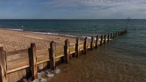 Seashore Nature View Moving Along Wooden Groyne With Long Coastal Shadows Stock Footage 341865430