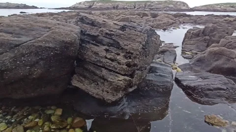 Seashore with rocks at low tide Stock Footage 240293921