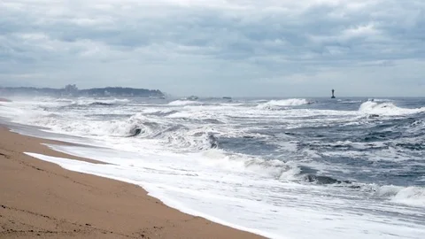 A seashore scene in which high waves come with cloudy weather and strong winds. Stock Footage 117394609