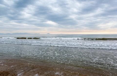 Seashore with storm wave and clouds Stock Photos