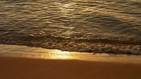 Seashore at Sunset. Small Waves Roll on the Shore. Golden Time. The Rays of the Video stock 247175518